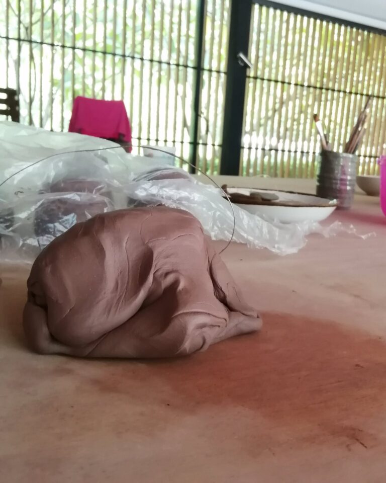 A block of freshly wedged clay on the studio table at Klei
