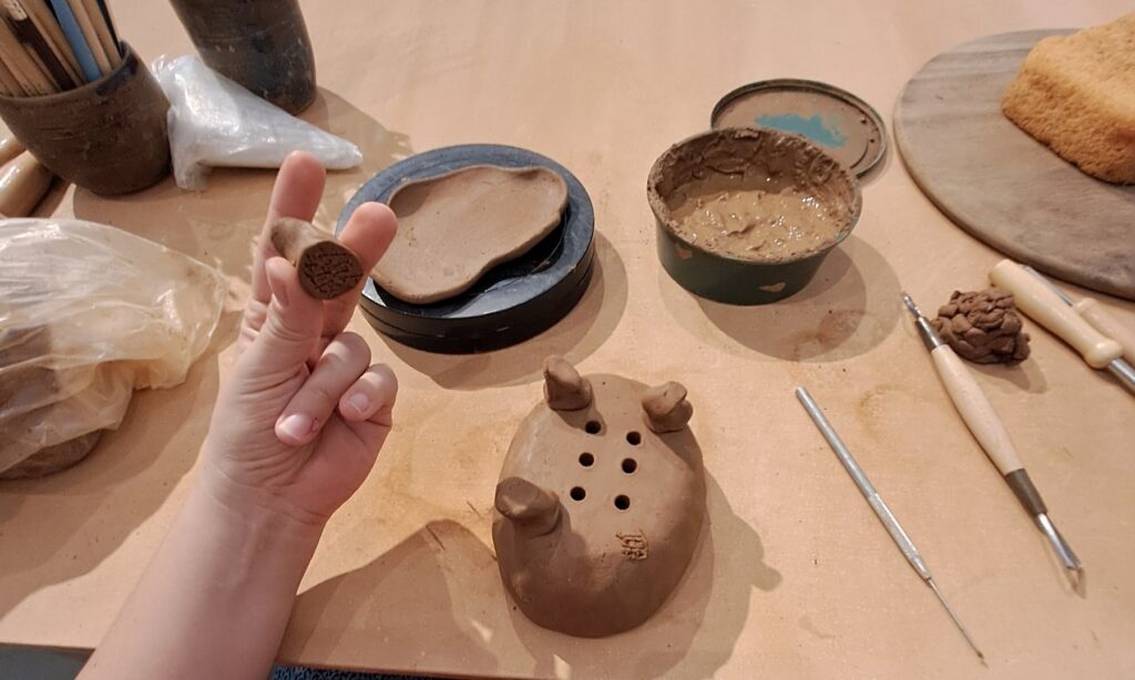 Students handbuilding at the studio table