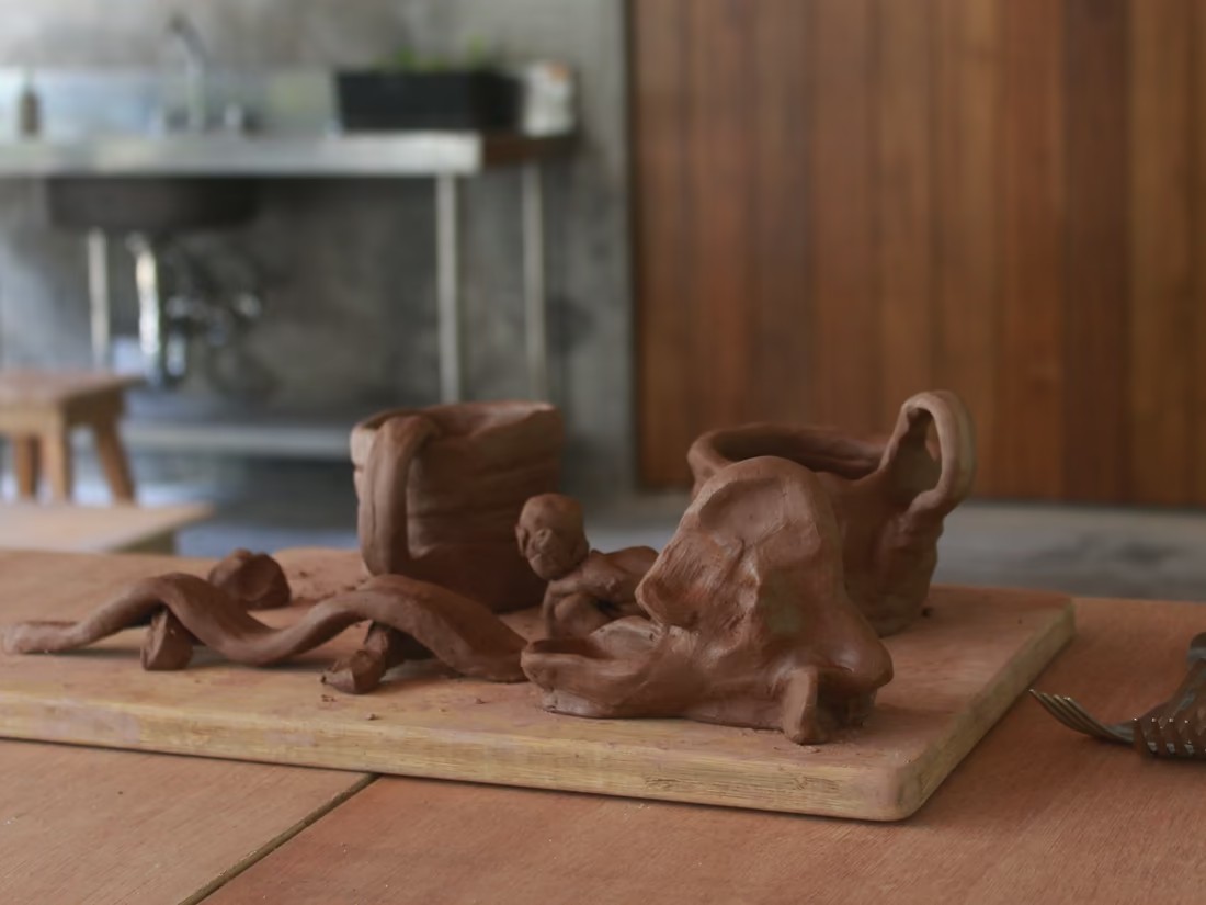 Handbuilt clay pieces on a wooden board at the Klei studio