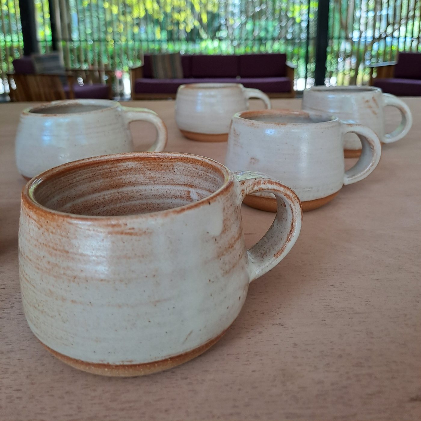 Finished handmade mugs ready to take home, on the studio table