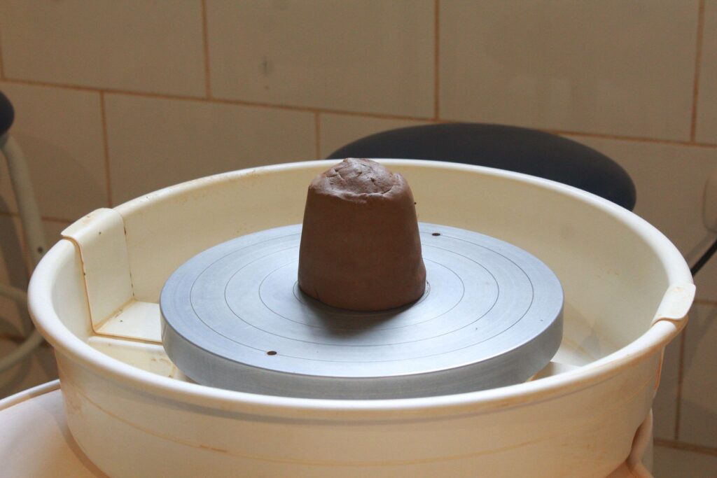 A lump of clay on the pottery wheel